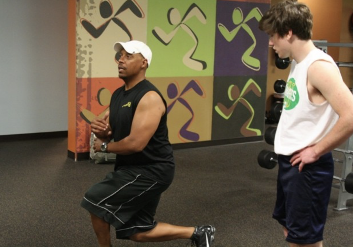 TEACHING TECHNIQUE: Trainer Monte’ Nash shows St. Joseph junior Scotty Cusack the proper method for a squat. (Jeremy Thomas/Staff)